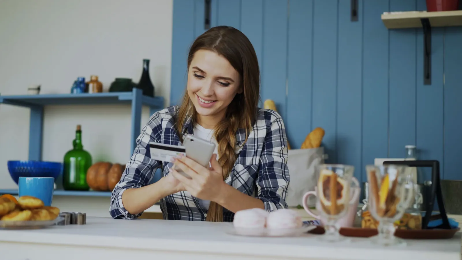 Person comparing online bank options on a phone and laptop, 2026 banking review