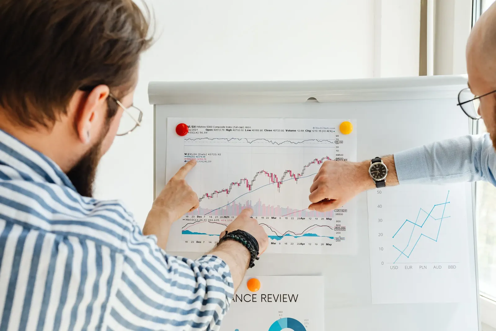 Frustrated beginner investor reviewing a declining portfolio chart